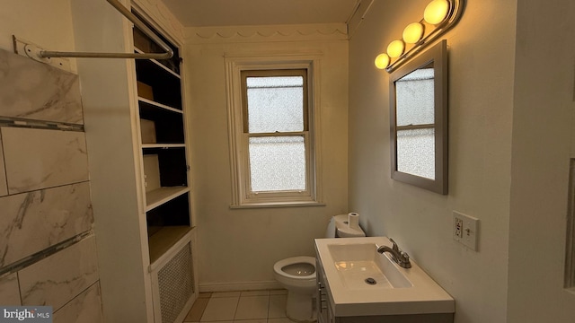 bathroom with tile patterned floors, toilet, radiator, and vanity