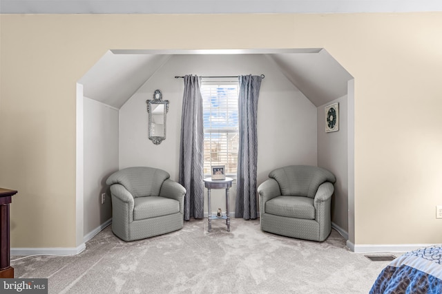 living area with carpet floors and vaulted ceiling