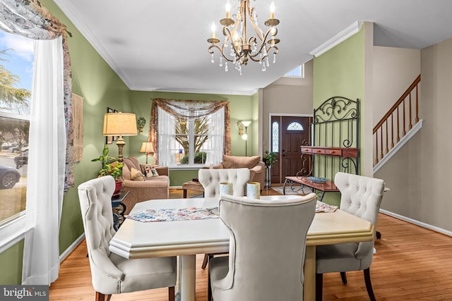 dining room with ornamental molding, plenty of natural light, and light wood-type flooring