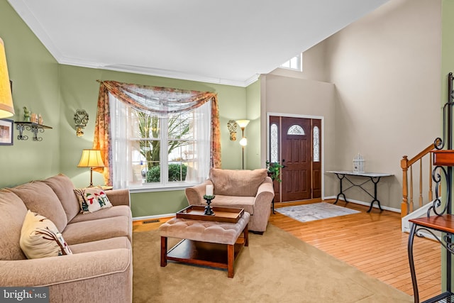 living room with hardwood / wood-style flooring and ornamental molding