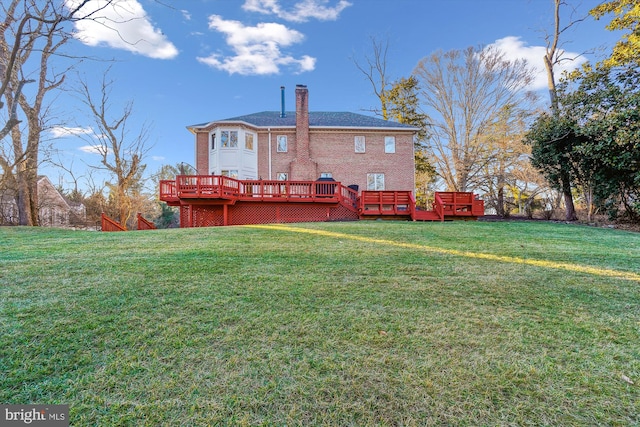 back of house with a wooden deck and a yard