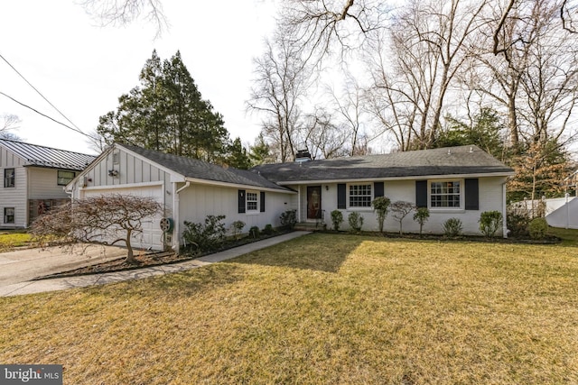 ranch-style house featuring an attached garage, fence, driveway, board and batten siding, and a front yard