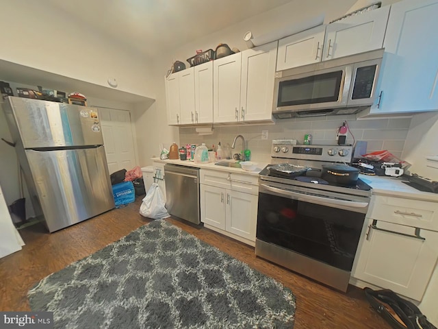 kitchen featuring stainless steel appliances, sink, white cabinets, and backsplash