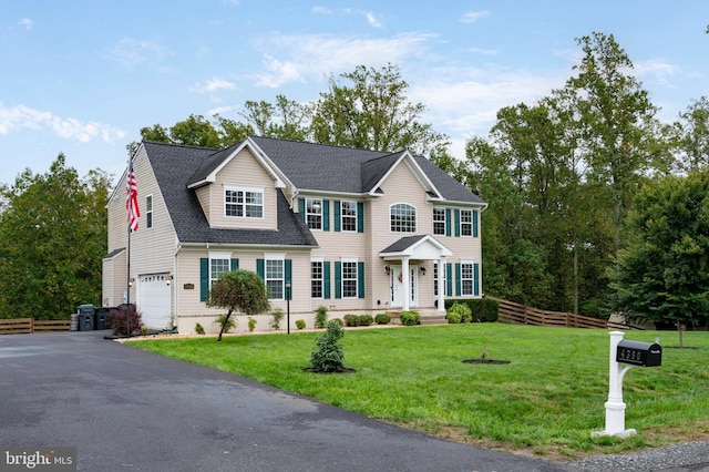 view of front of home with a garage and a front yard