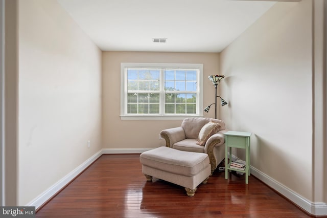 sitting room with dark wood-type flooring