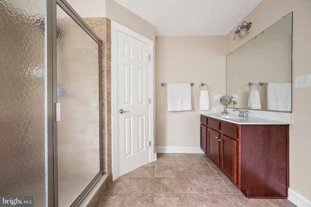 bathroom featuring tile patterned flooring, vanity, and a shower with shower door