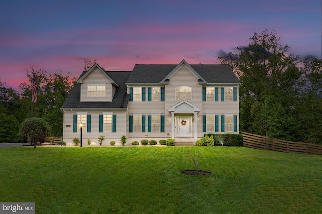 colonial-style house featuring a yard