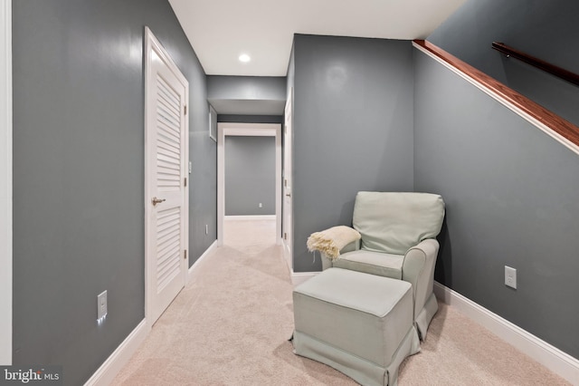 sitting room featuring light colored carpet