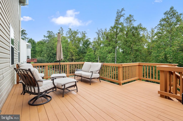 wooden terrace with an outdoor living space