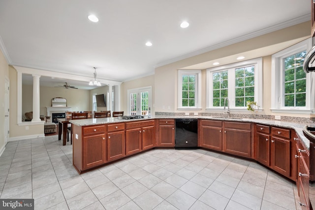 kitchen with dishwasher, sink, light stone counters, and kitchen peninsula