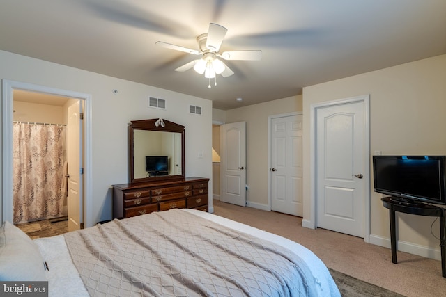 carpeted bedroom with ceiling fan and ensuite bathroom