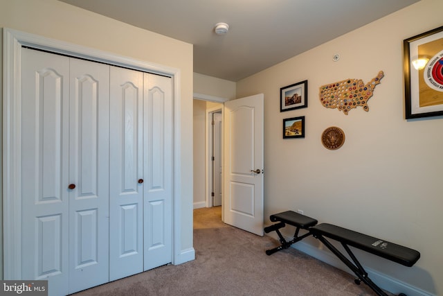 workout room with light colored carpet