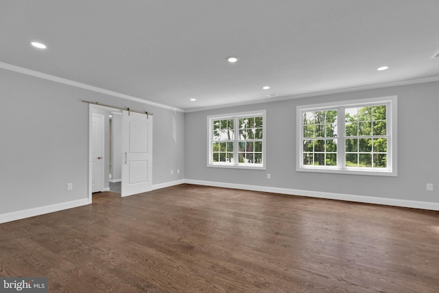 empty room with dark wood-style floors, baseboards, and crown molding