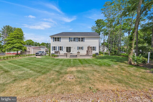 back of property featuring a patio area and a yard