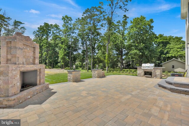 view of patio / terrace with an outdoor stone fireplace