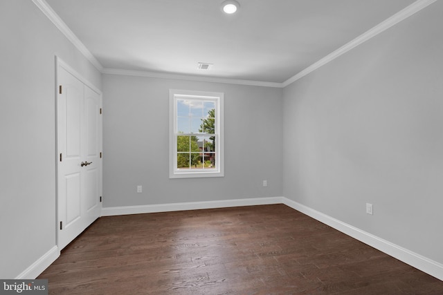 interior space with ornamental molding, visible vents, dark wood finished floors, and baseboards