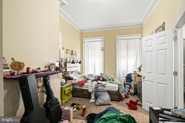 carpeted bedroom featuring crown molding