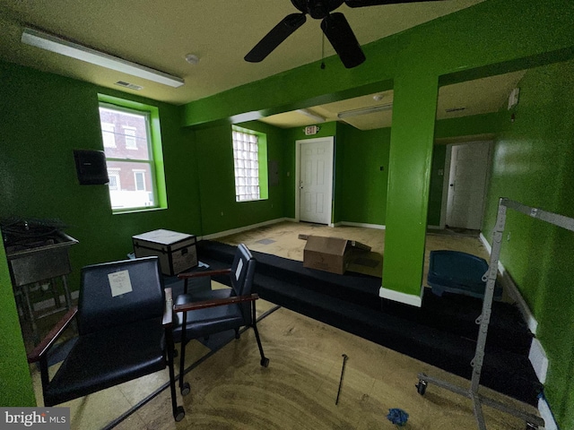 interior space with ceiling fan and a wealth of natural light