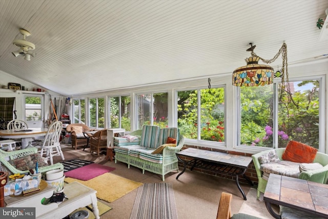 sunroom / solarium featuring lofted ceiling