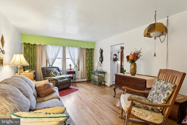 living room featuring light hardwood / wood-style flooring and a baseboard heating unit