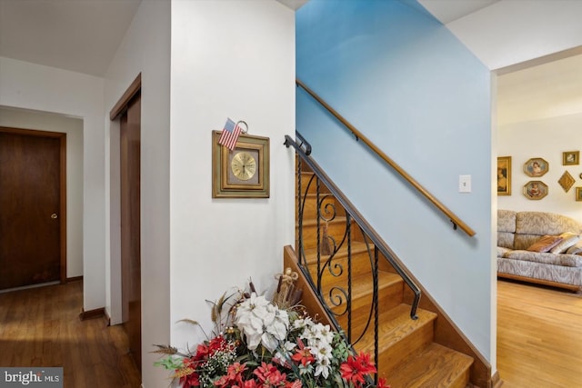 stairs featuring hardwood / wood-style floors