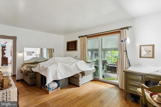 bedroom featuring access to exterior and light hardwood / wood-style floors