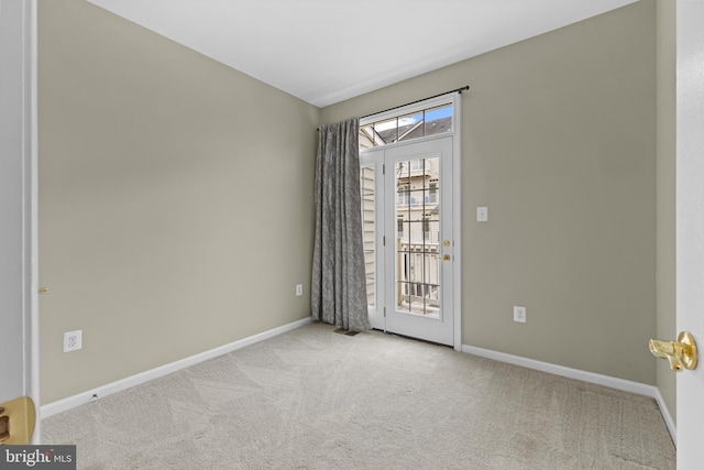 spare room with light carpet, visible vents, and baseboards