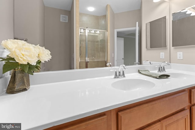 bathroom featuring visible vents, a shower stall, and vanity