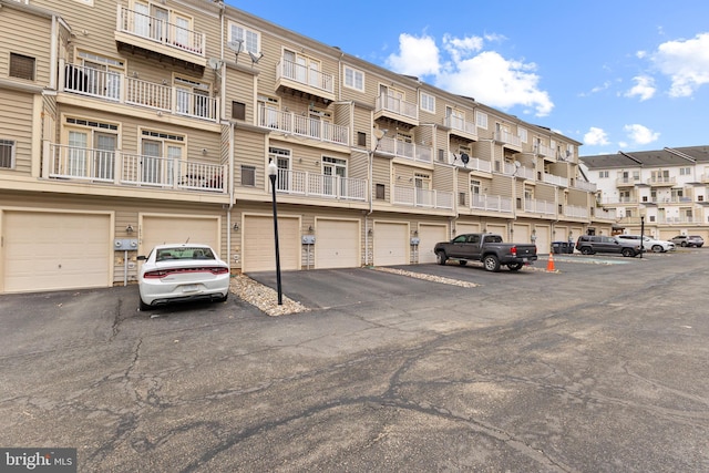 view of building exterior featuring driveway and an attached garage