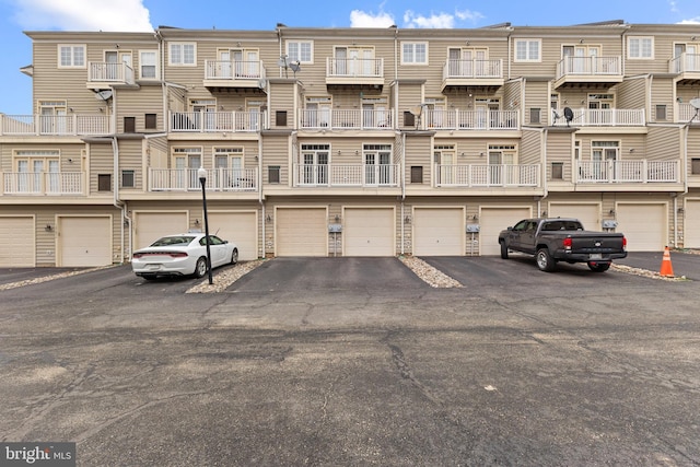 view of building exterior with driveway and an attached garage