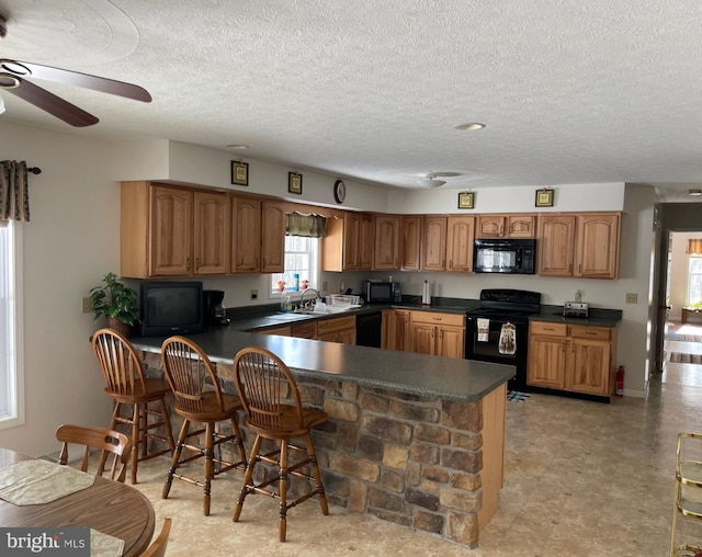 kitchen with black appliances, sink, ceiling fan, kitchen peninsula, and a textured ceiling