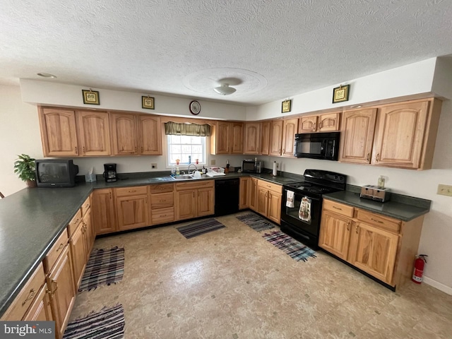 kitchen featuring sink, black appliances, and a textured ceiling