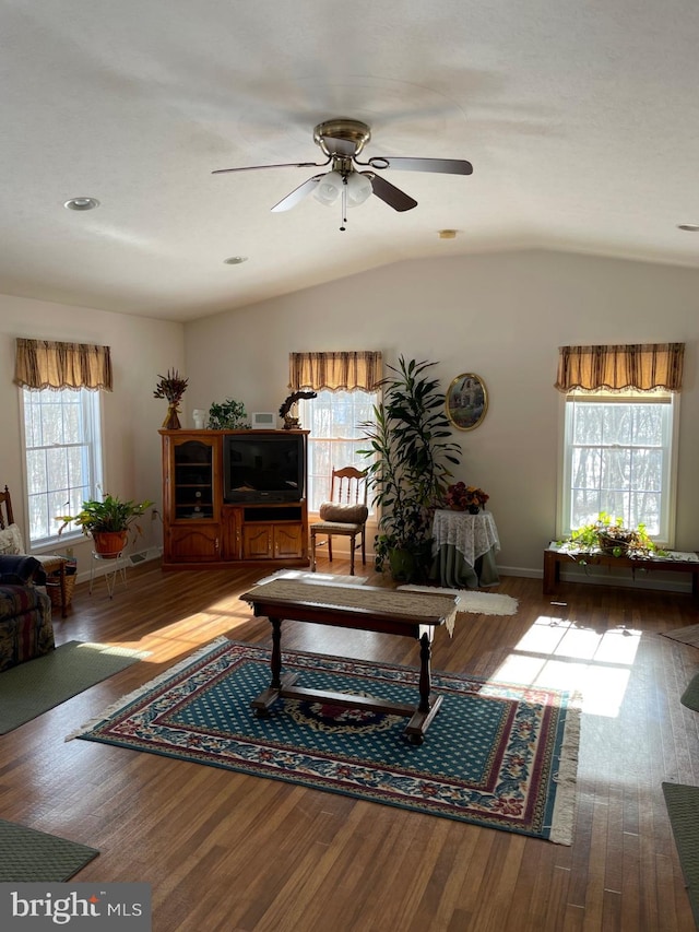 living room featuring lofted ceiling, hardwood / wood-style floors, and ceiling fan