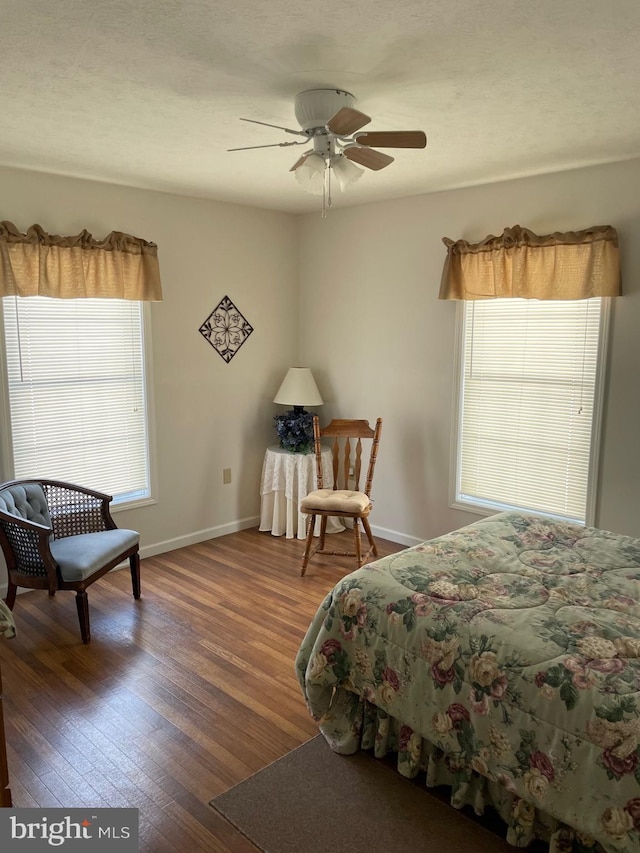 bedroom with dark hardwood / wood-style floors and ceiling fan