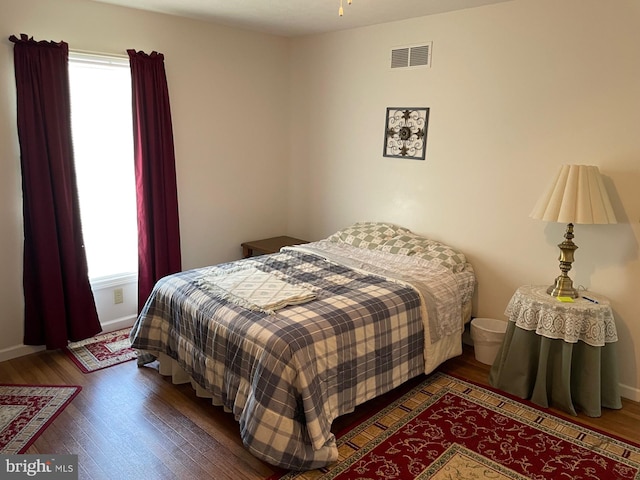 bedroom with dark wood-type flooring