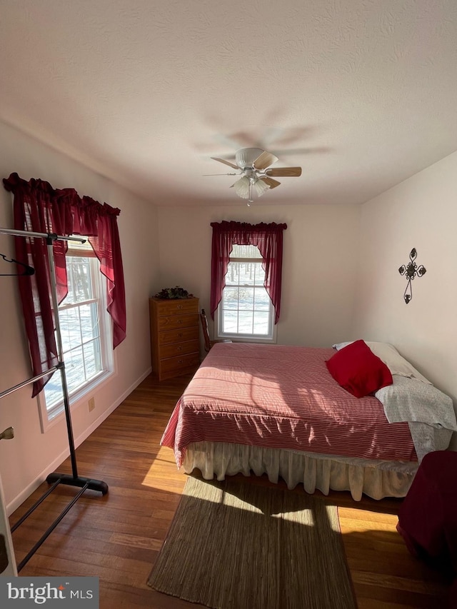 bedroom with ceiling fan and hardwood / wood-style floors