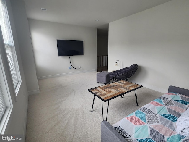 living room with light carpet and baseboards