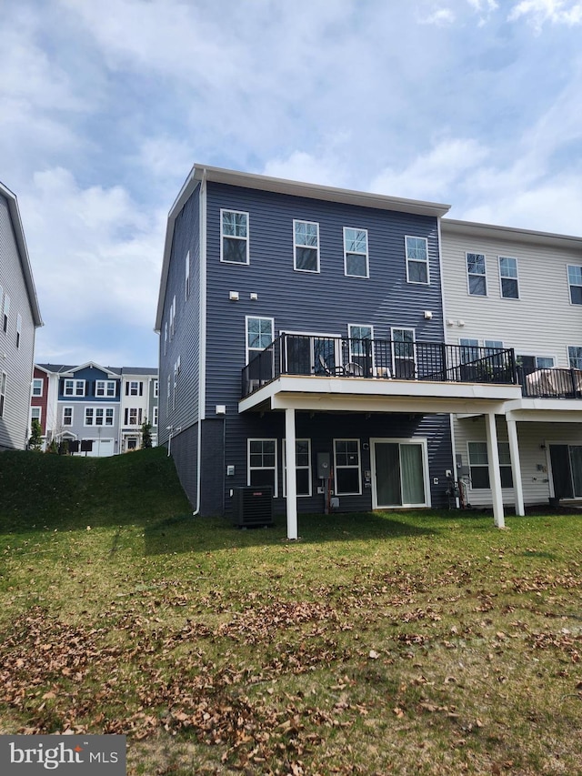 rear view of house featuring a yard and central AC unit