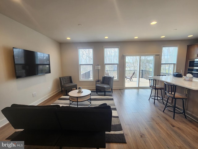 living area with light wood-style floors and recessed lighting