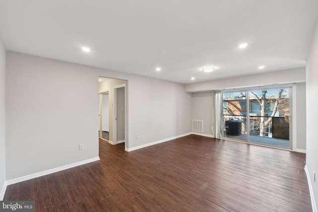 unfurnished room with dark hardwood / wood-style flooring