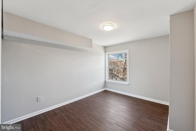 unfurnished room with dark hardwood / wood-style floors