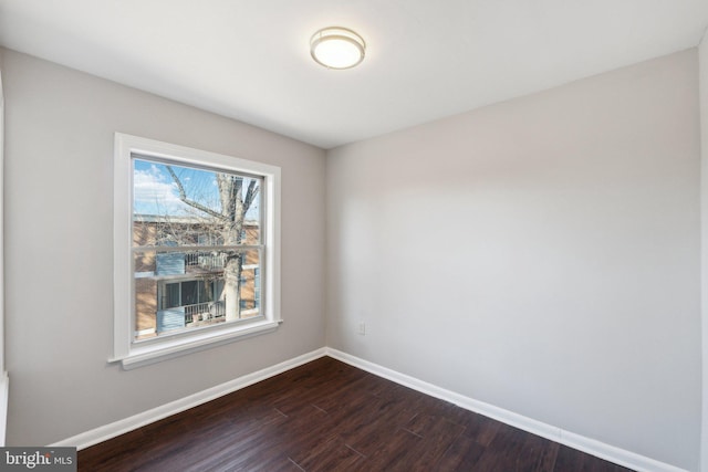 empty room featuring dark hardwood / wood-style flooring