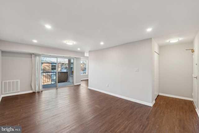 unfurnished living room featuring dark hardwood / wood-style floors