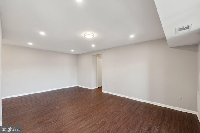 empty room with dark hardwood / wood-style flooring