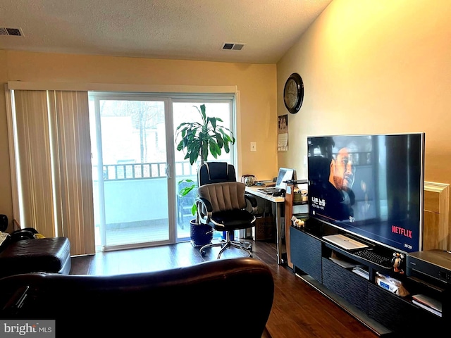 office featuring a textured ceiling and dark hardwood / wood-style flooring