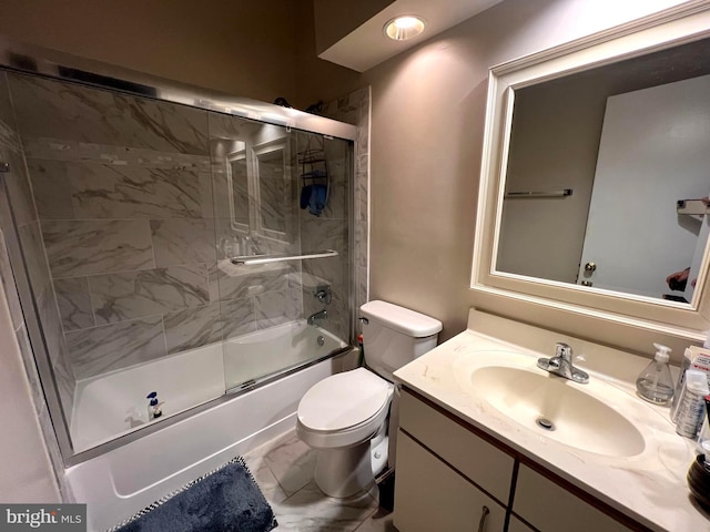 full bathroom with vanity, combined bath / shower with glass door, and toilet