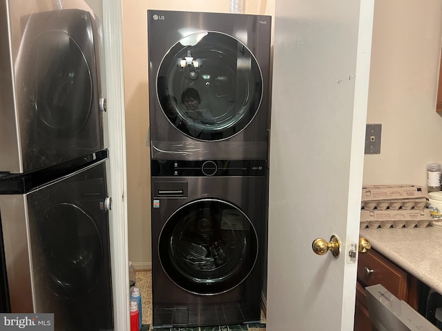 laundry area with stacked washer and dryer