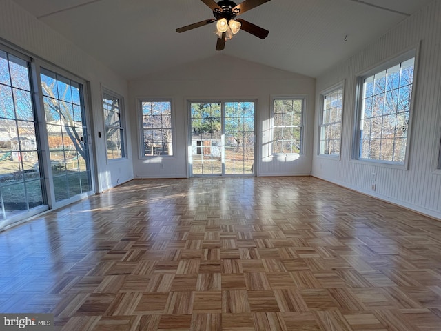 unfurnished sunroom with a ceiling fan and vaulted ceiling