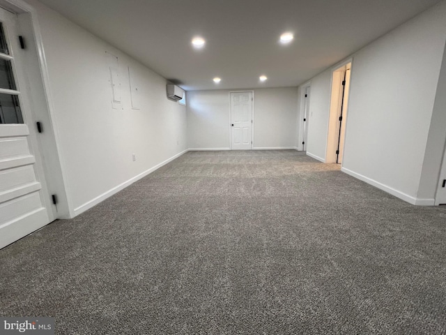 finished basement with carpet floors, an AC wall unit, recessed lighting, and baseboards