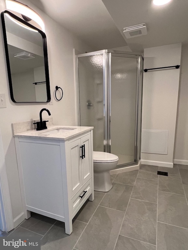 bathroom featuring toilet, a shower stall, visible vents, and vanity